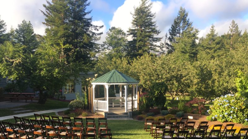 Gazebo wedding ceremony with brown chairs at Mitchell Grove