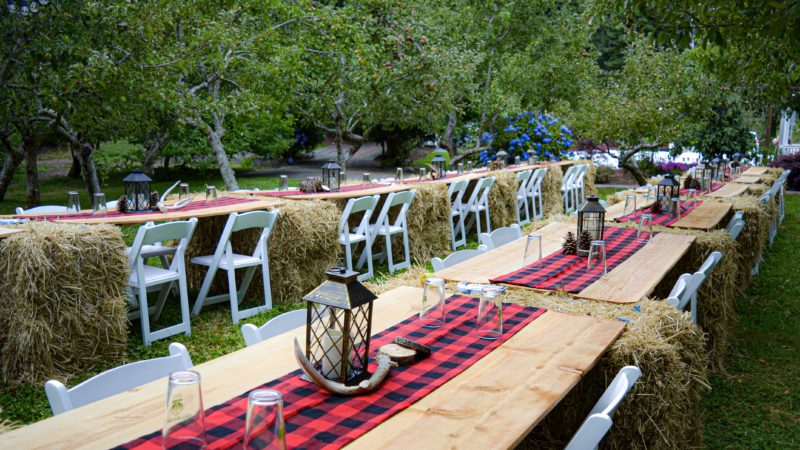 DIY wedding reception setup with hay bales, fence posts, and a cordless drill after tables in town were unavailable