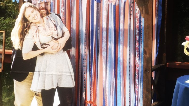 DIY wedding photo booth with cardboard cutout couple and decorated arch at Mitchell Grove in Humboldt, Northern California