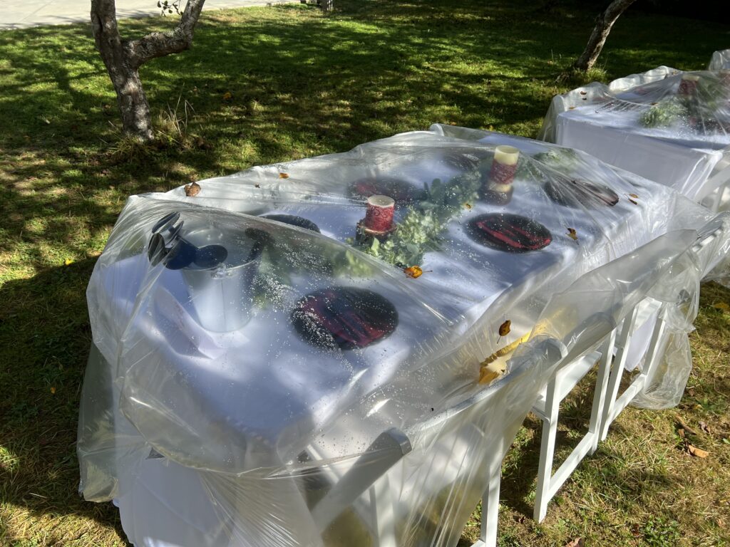 Plastic covering set table the night before wedding so dew did not wet the table.