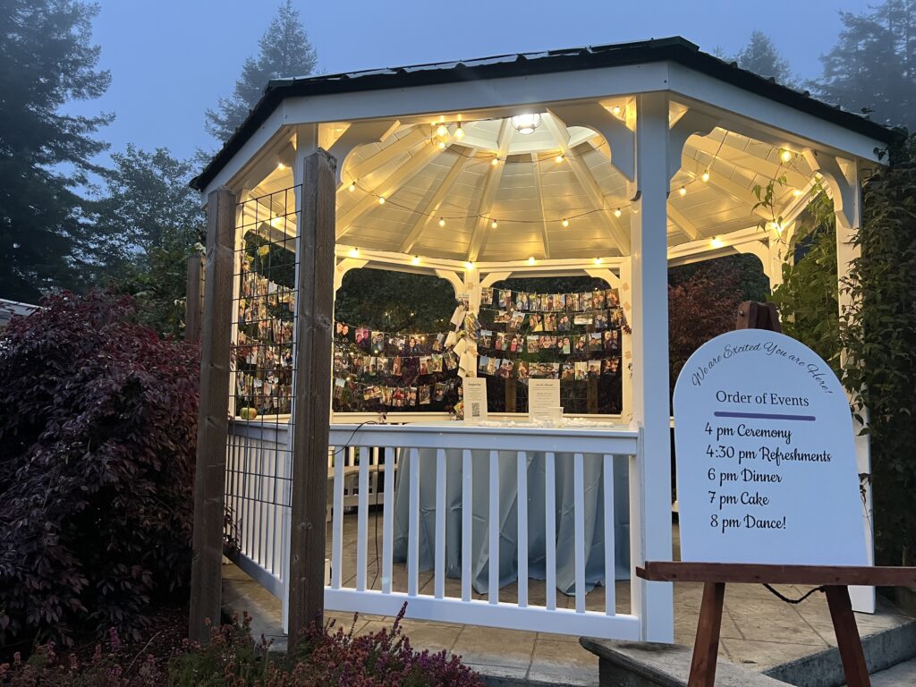 Wooden easel holding a wedding sign in front of the gazebo at Mitchell Grove, a unique rustic outdoor wedding venue in Northern California for alternative and DIY celebrations.