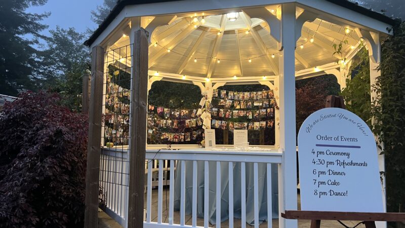 Wooden easel holding a wedding sign in front of the gazebo at Mitchell Grove, a unique rustic outdoor wedding venue in Northern California for alternative and DIY celebrations.