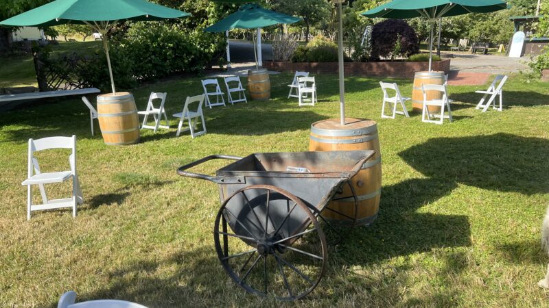Budget garden wedding reception setup at Mitchell Grove in Humboldt County with tables, chairs, and décor from the lending closet.