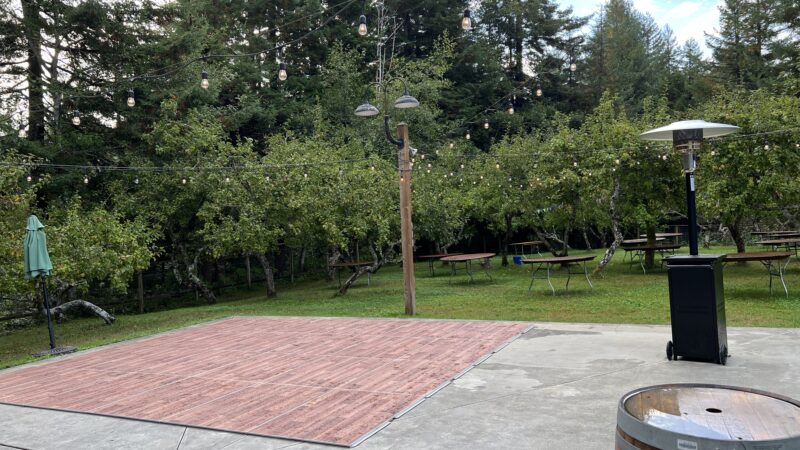 Outdoor wedding reception setup with a simple dance floor at Mitchell Grove, chosen by a couple who prioritized swing dancing and live music.