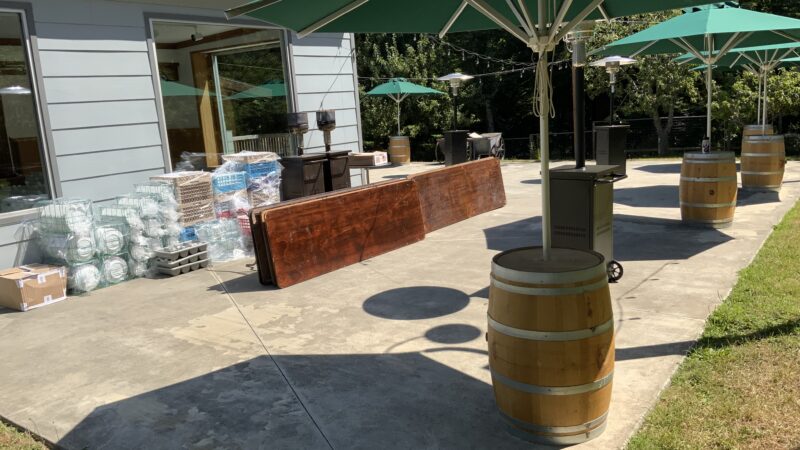 DIY orchard wedding setup with free umbrellas and barrels at Mitchell Grove, showing Thursday drop-off before a weekend celebration in Humboldt County.