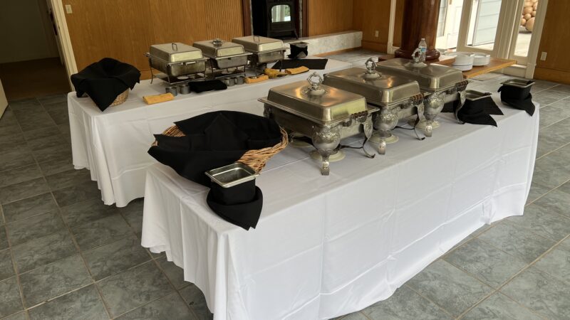 Affordable DIY buffet setup with silver chafing dishes inside the Mitchell Grove hall for a budget-friendly wedding